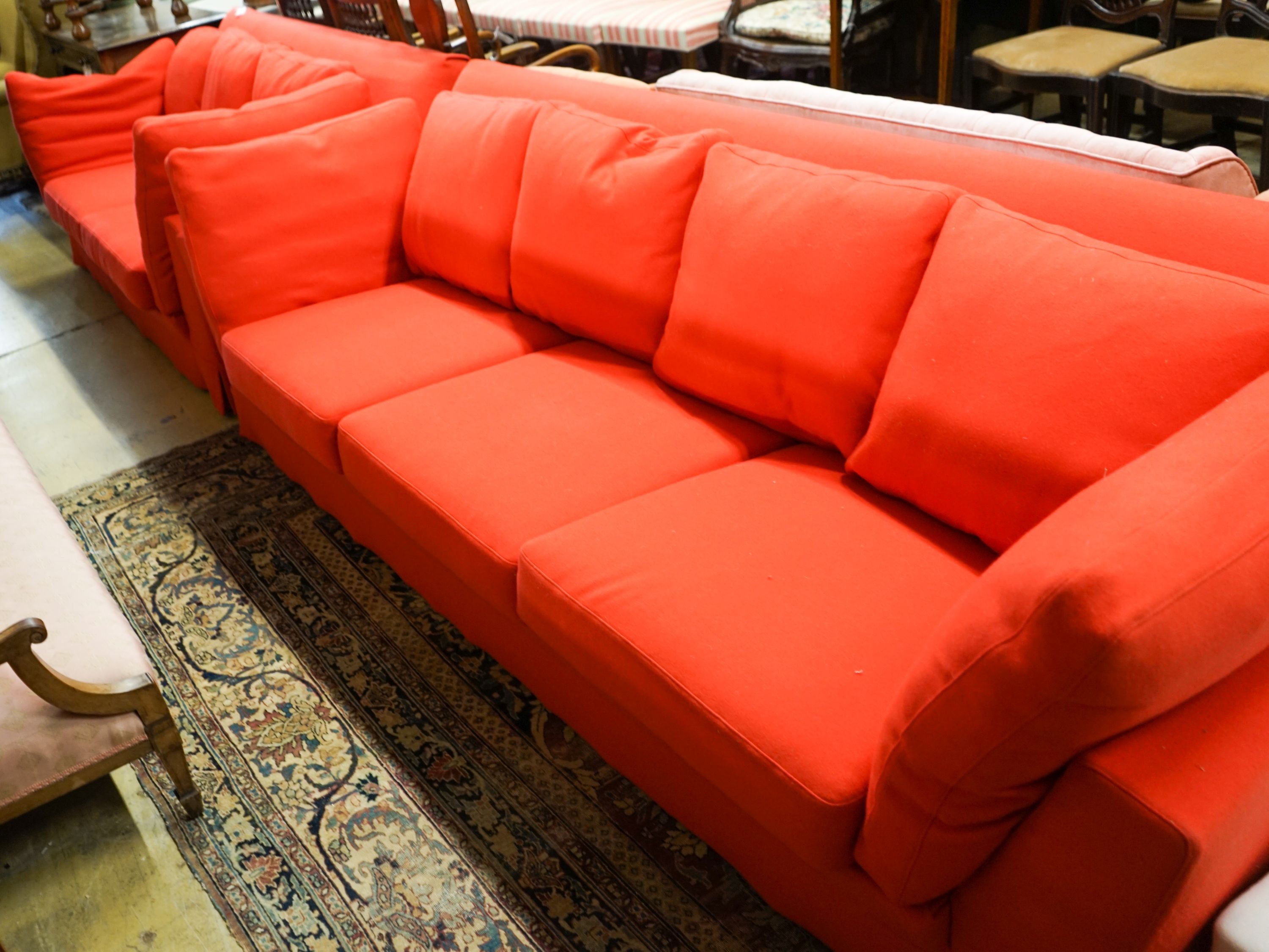 A contemporary Moroso three seater and two seater sofa upholstered in red fabric, the larger length 250cm, depth 100cm, height 79cm